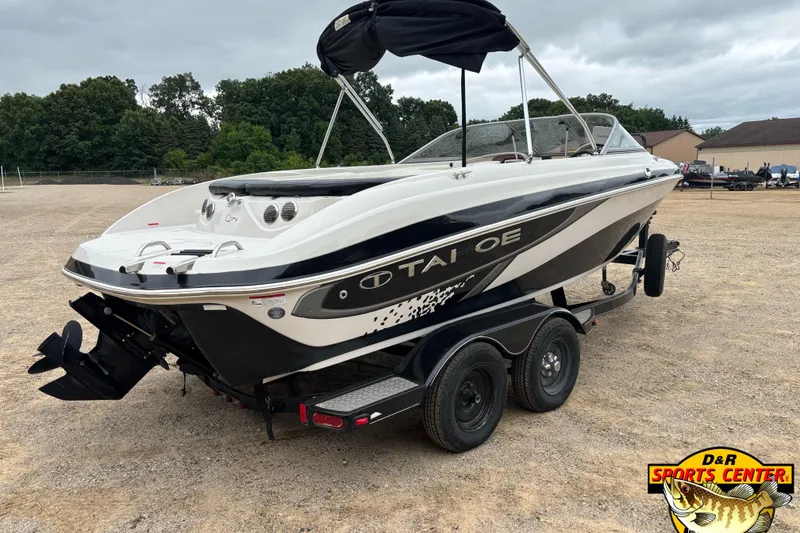 Slide: The Image of 2011 Tahoe Q7i boat on trailer, parked outdoors with overcast sky. - 25