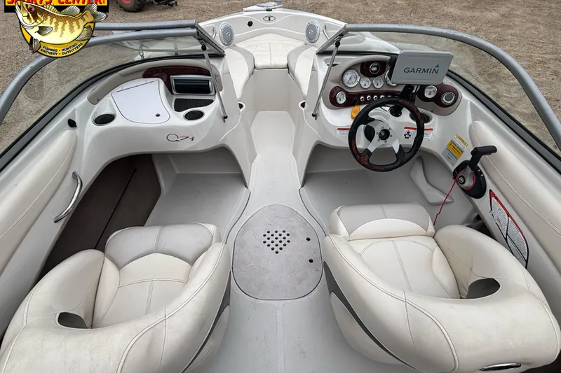 Slide: The Image of 2011 Tahoe Q7i boat interior with white seating and Garmin navigation system. - 27