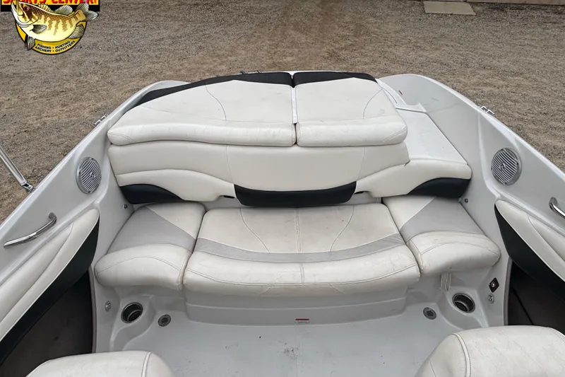 Slide: The Image of 2011 Tahoe Q7i boat interior with white cushioned seating and built-in speakers. - 29