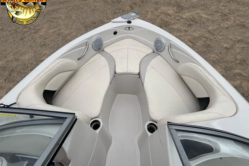 Slide: The Image of 2011 Tahoe Q7i boat interior with white seating and cup holders. - 31