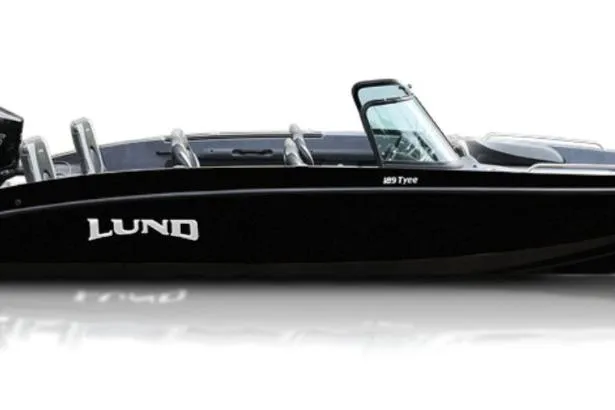 The Image of 2026 Lund 189 Tyee GL boat on trailer outside showroom, featuring sleek blue and gray design. - 0