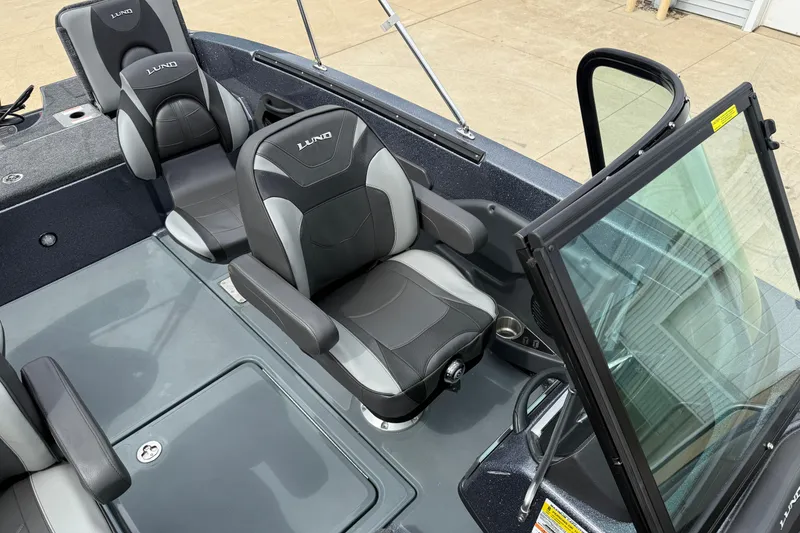 Slide: The Image of 2026 Lund 189 Tyee GL boat battery compartment with wiring and charger. - 16