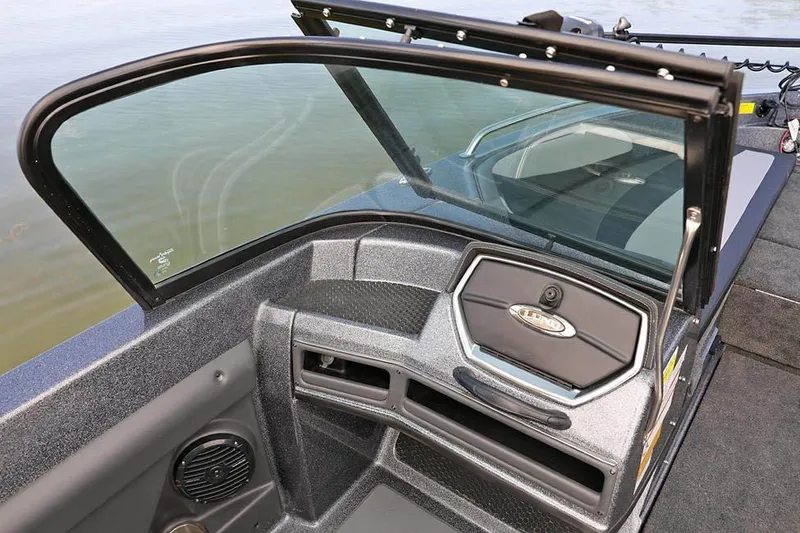 Slide: The Image of 2026 Lund 189 Tyee GL boat on trailer, parked outside a building. - 2