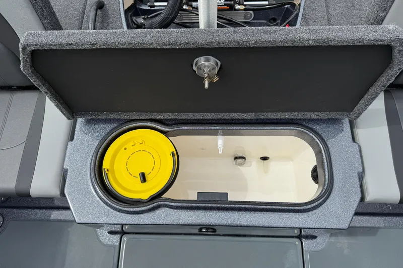 Slide: The Image of 2026 Lund 189 Tyee GL boat interior storage compartment with seat and warning label. - 31