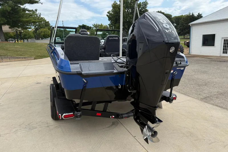 Slide: The Image of 2026 Lund 189 Tyee GL boat with powerful outboard motor, parked on a trailer. - 7