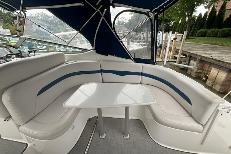 Slide: The Image of 2003 Chaparral 310 Signature boat interior with cushioned seating and table. - 10