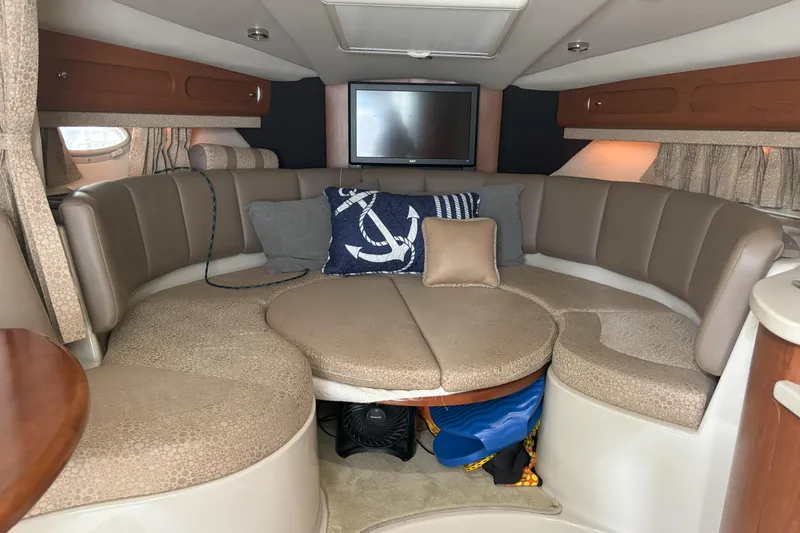 Slide: The Image of 2003 Chaparral 310 Signature boat interior with cozy seating and nautical decor. - 17