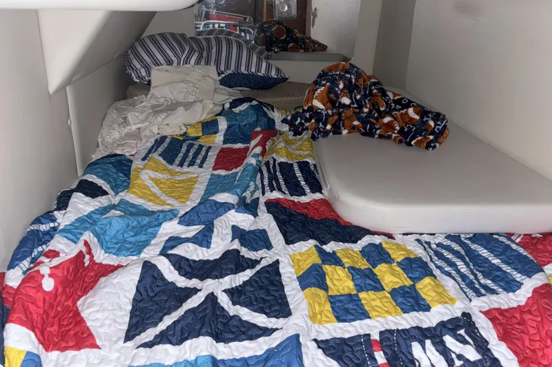 Slide: The Image of Cozy cabin interior of 2003 Chaparral 310 Signature with colorful quilt and pillows. - 20