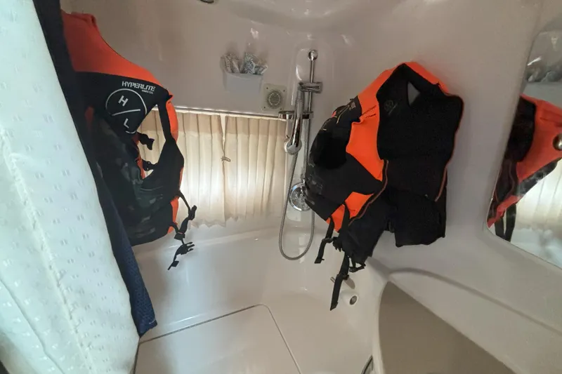 Slide: The Image of Interior of 2003 Chaparral 310 Signature boat with life jackets in shower area. - 5