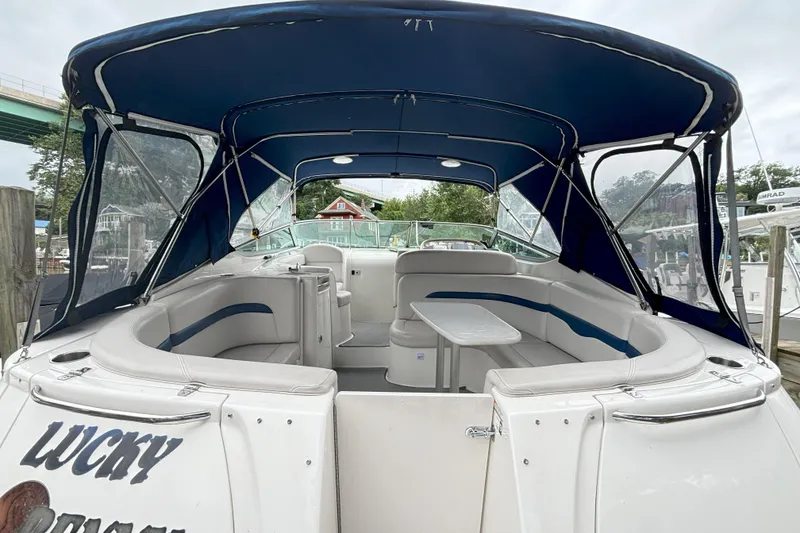 Slide: The Image of 2003 Chaparral 310 Signature boat with blue canopy and spacious seating area. - 9