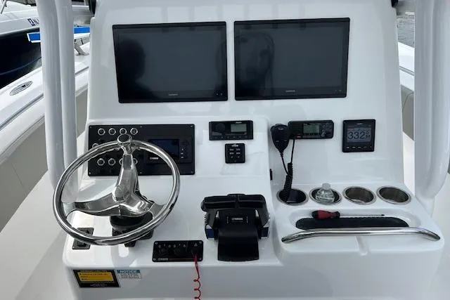 Slide: The Image of 2022 Cape Horn 32 T boat dashboard with dual screens and steering wheel. - 14