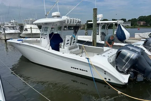 Slide: The Image of 2022 Cape Horn 32 T boat docked, featuring Yamaha engines and sleek design. - 2