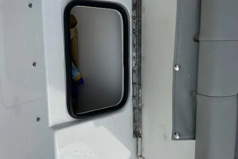 Slide: The Image of 2022 Cape Horn 32 T boat window detail with visible interior. - 10