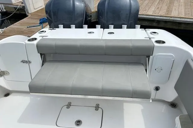 Slide: The Image of 2022 Cape Horn 32 T boat with gray seating and dual outboard motors at dock. - 12