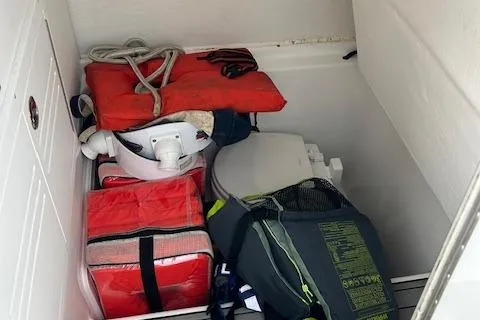 Slide: The Image of Storage compartment in a 2022 Cape Horn 32 T boat with life jackets and gear. - 18