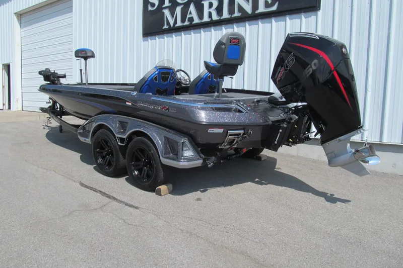 Slide: The Image of 2026 Ranger Z520 boat with powerful outboard motor, parked outside a marine store. - 3