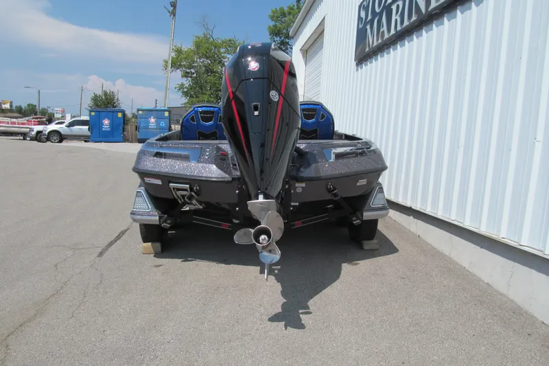 Slide: The Image of 2026 Ranger Z520 boat parked outside a marine store, rear view. - 4