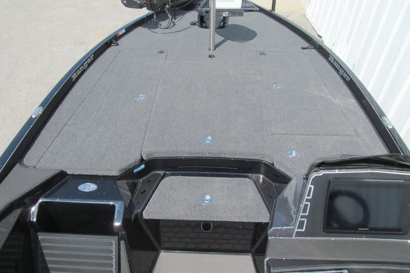 Slide: The Image of 2026 Ranger Z520 boat deck with carpeted surface and control panel. - 7