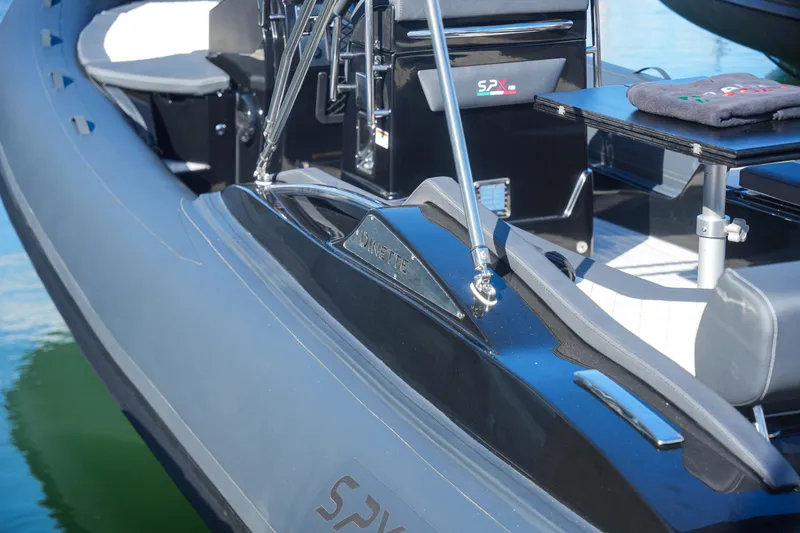 Slide: The Image of 2023 SPX RIB 25 Dinette boat interior with seating and table. - 10