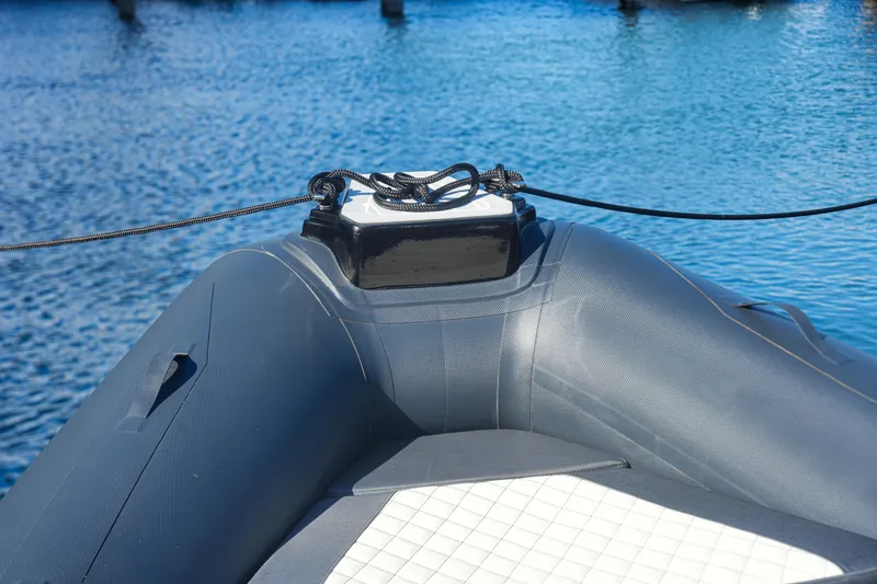 Slide: The Image of Bow of 2023 SPX RIB 25 Dinette boat on water. - 13