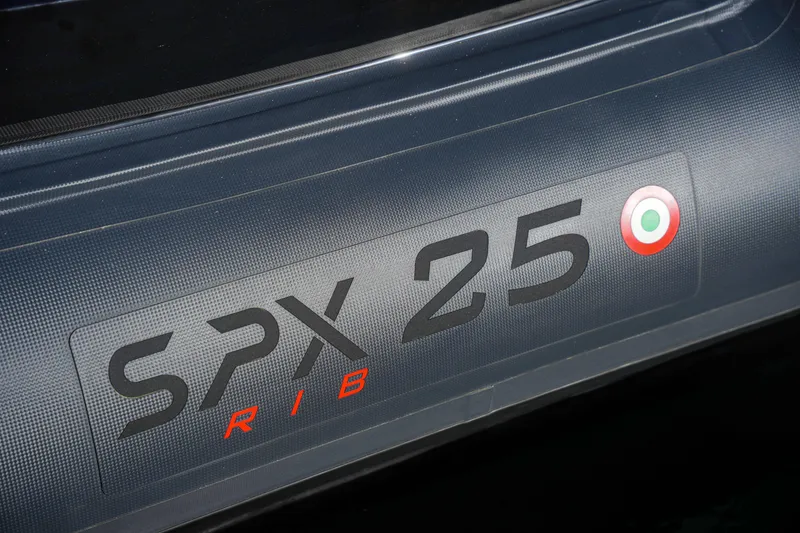 Slide: The Image of SPX RIB 25 Dinette 2023 model branding on boat exterior. - 15