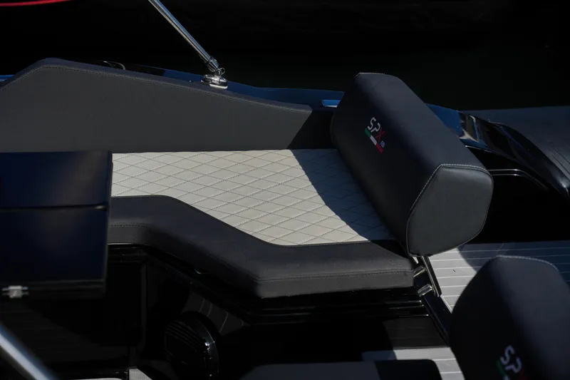 Slide: The Image of 2023 SPX RIB 25 Dinette boat seating area with diamond-stitched upholstery. - 16