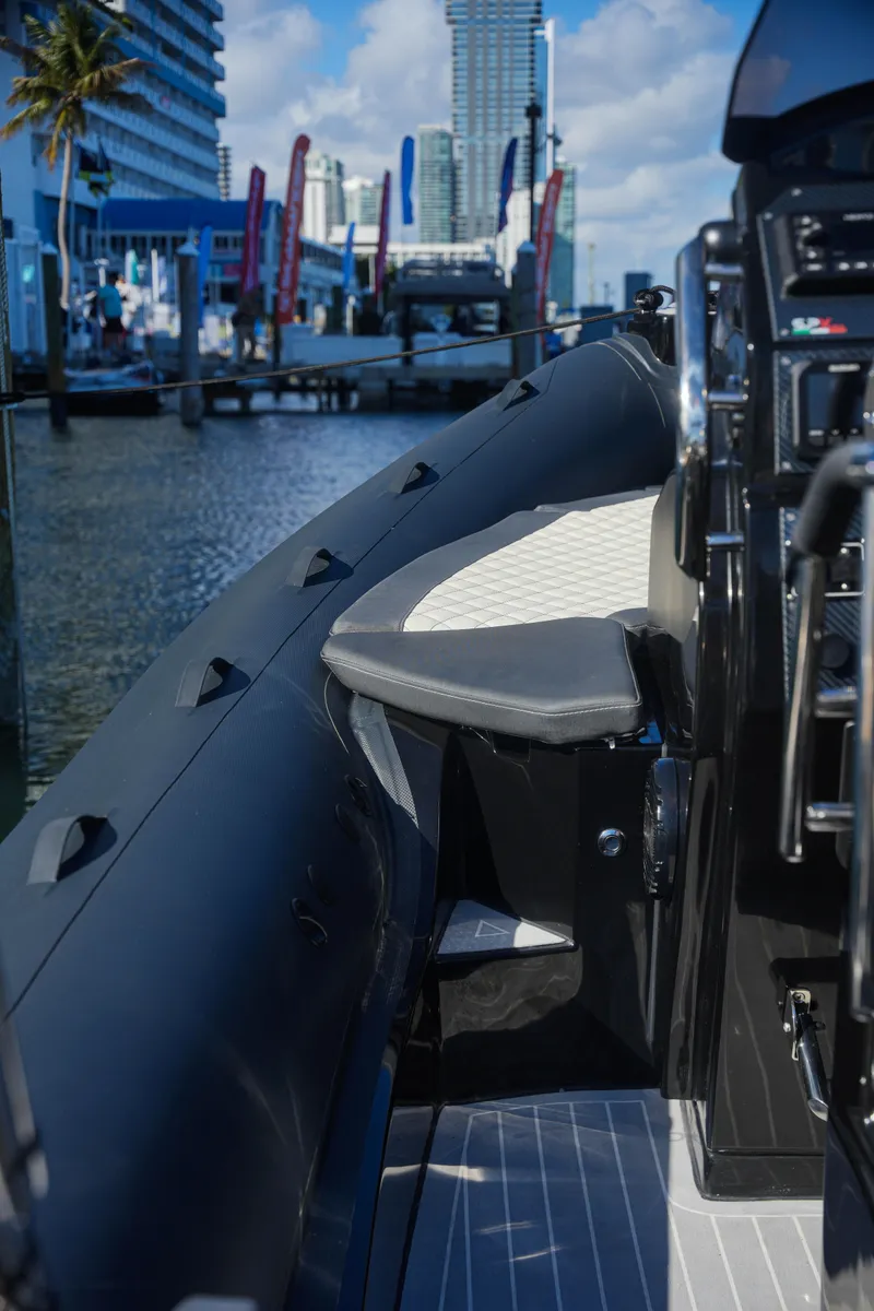 Slide: The Image of 2023 SPX RIB 25 Dinette at a marina, showcasing sleek design and modern features. - 17