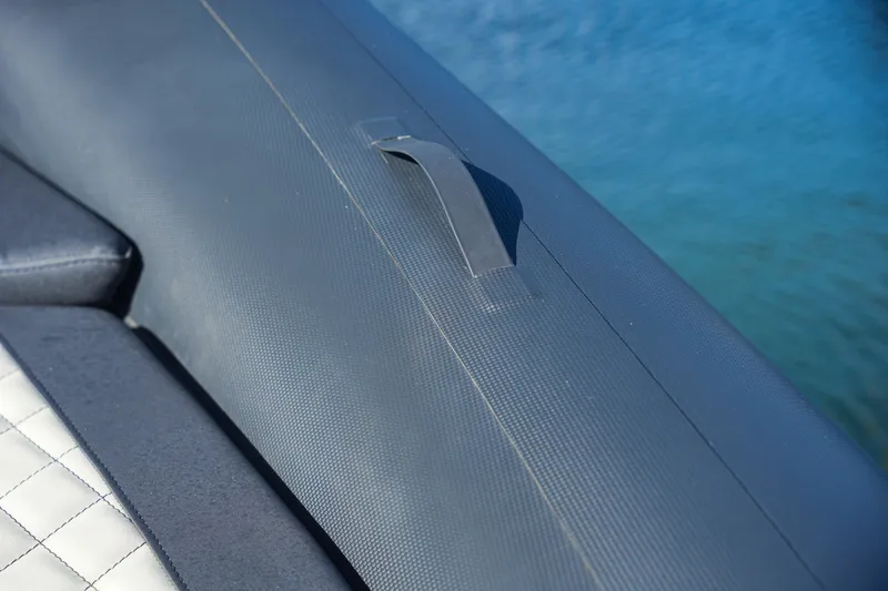 Slide: The Image of Close-up of SPX RIB 25 Dinette 2023 boat seat and handle. - 19