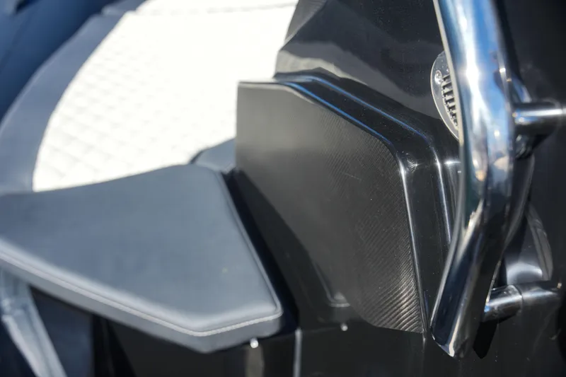 Slide: The Image of Close-up of 2023 SPX RIB 25 Dinette boat interior with sleek black and white design. - 24
