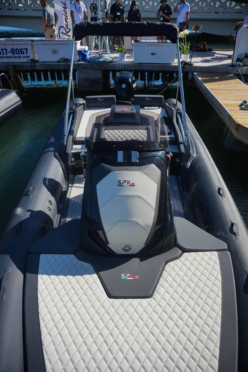 Slide: The Image of 2023 SPX RIB 25 Dinette inflatable boat docked at marina. - 3