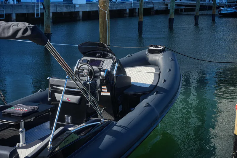 Slide: The Image of 2023 SPX RIB 25 Dinette boat docked at marina. - 6