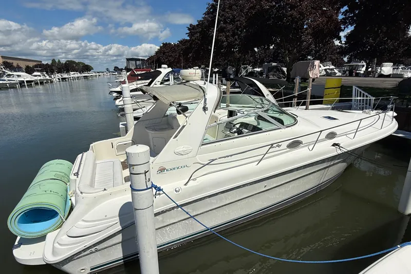 Slide: The Image of 1996 Sea Ray 330 Sundancer docked at marina under clear skies. - 0