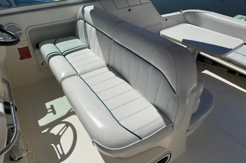 Slide: The Image of 1996 Sea Ray 330 Sundancer interior with white seating and table. - 12