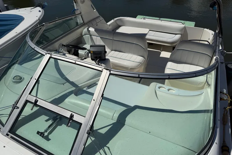 Slide: The Image of 1996 Sea Ray 330 Sundancer boat interior with white seating and steering wheel. - 14