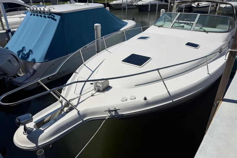 Slide: The Image of 1996 Sea Ray 330 Sundancer docked at marina, featuring sleek white design. - 18