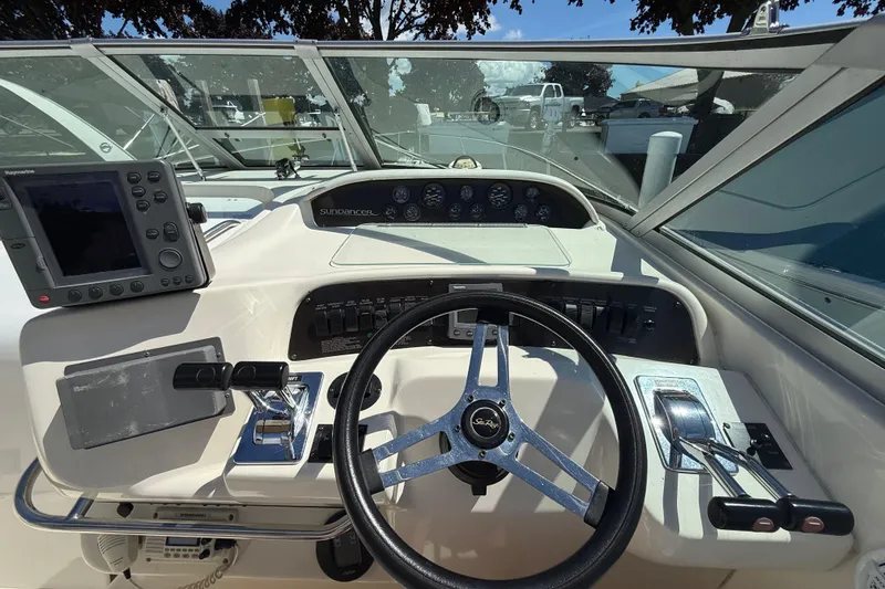 Slide: The Image of 1996 Sea Ray 330 Sundancer helm with steering wheel, controls, and navigation equipment. - 21