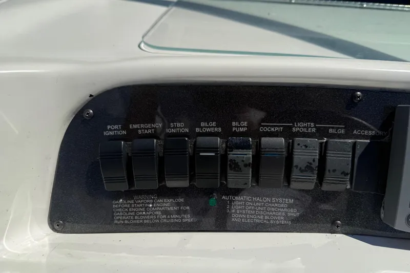 Slide: The Image of Control panel of a 1996 Sea Ray 330 Sundancer boat with various switches. - 22