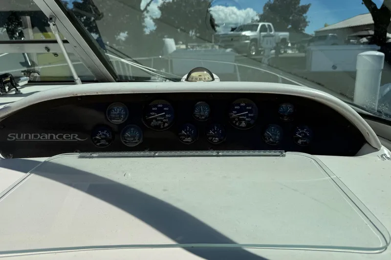 Slide: The Image of Dashboard of a 1996 Sea Ray 330 Sundancer boat with gauges and controls. - 23