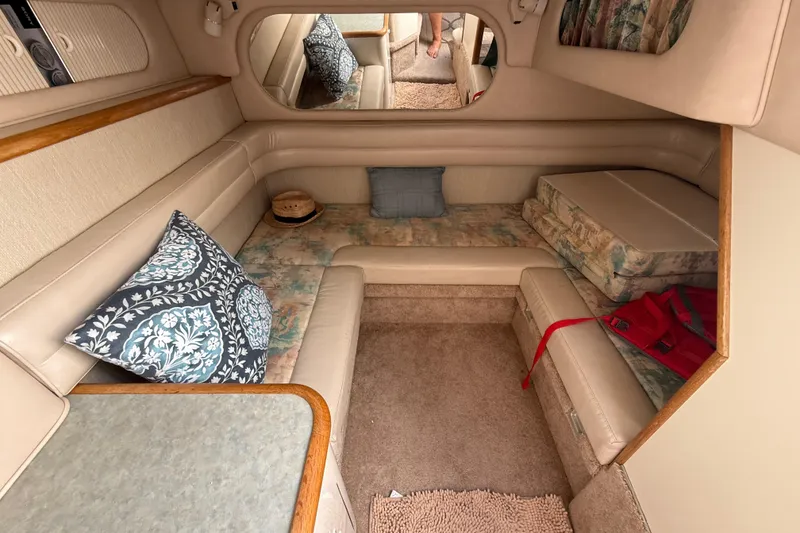 Slide: The Image of 1996 Sea Ray 330 Sundancer cabin interior with cushions and pillows. - 27