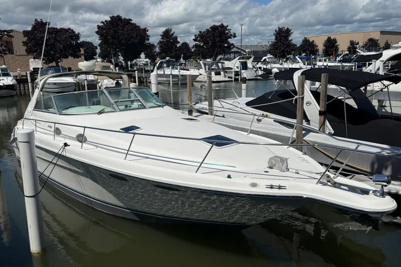 Slide: The Image of 1996 Sea Ray 330 Sundancer docked at marina under cloudy sky. - 3