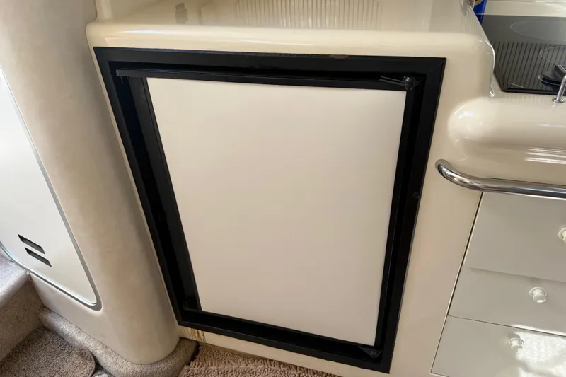 Slide: The Image of 1996 Sea Ray 330 Sundancer interior with built-in refrigerator and cabinetry. - 33