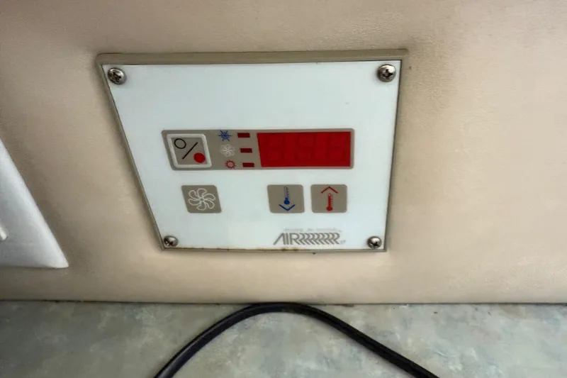 Slide: The Image of Control panel of a 1996 Sea Ray 330 Sundancer boat, featuring temperature and fan settings. - 36