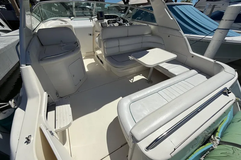 Slide: The Image of 1996 Sea Ray 330 Sundancer boat interior with seating and table. - 4