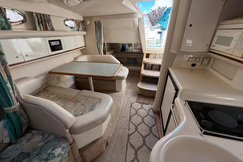 Slide: The Image of Interior of 1996 Sea Ray 330 Sundancer yacht with dining area and kitchenette. - 40