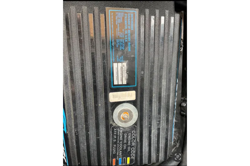 Slide: The Image of Engine cover of a 1996 Sea Ray 330 Sundancer boat with label details. - 46