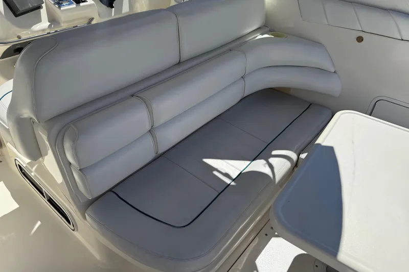 Slide: The Image of 1996 Sea Ray 330 Sundancer interior seating with white upholstery and table. - 7