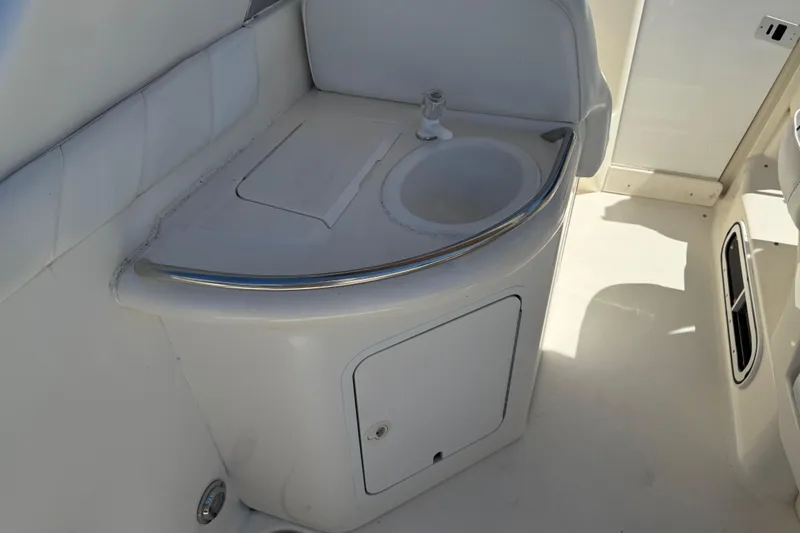 Slide: The Image of 1996 Sea Ray 330 Sundancer boat interior with sink and storage cabinet. - 8