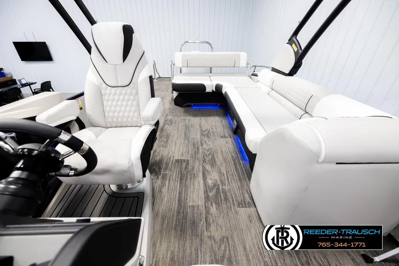 Slide: The Image of Luxurious interior of 2026 Avalon Excal LTD CRB boat with white seating and blue LED lighting. - 14