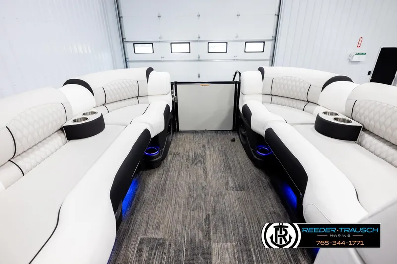 Slide: The Image of Luxurious interior of 2026 Avalon Excal LTD CRB boat with plush seating and cup holders. - 19