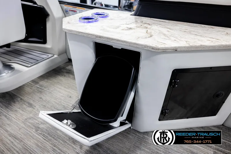 Slide: The Image of 2026 Avalon Excal LTD CRB boat interior with storage compartment and marble countertop. - 29